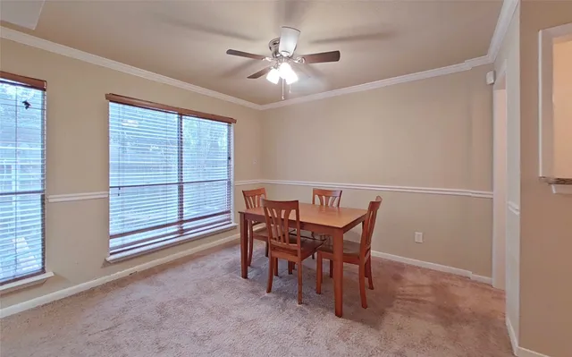 a view of a dining room with furniture and a chandelier