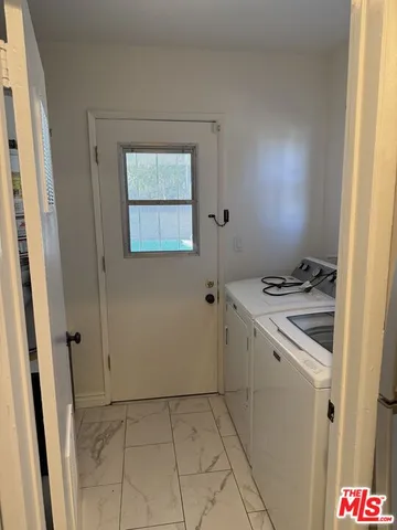 a storage room with a stove top oven and sink