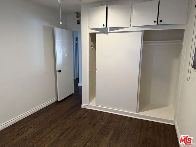 an empty room with wooden floor