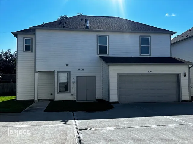 a black and white building with a black gate