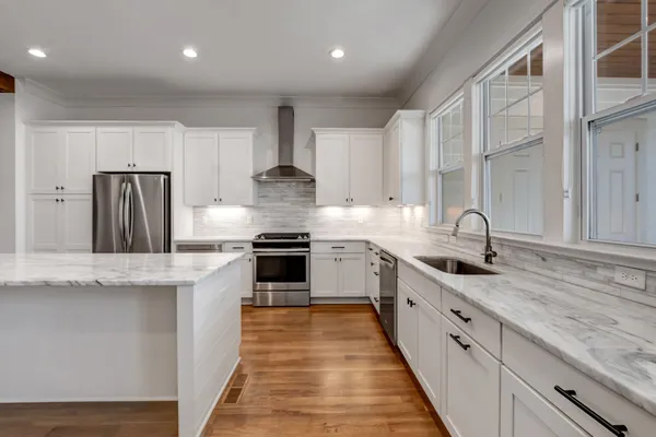 a kitchen with stainless steel appliances granite countertop a stove and a refrigerator