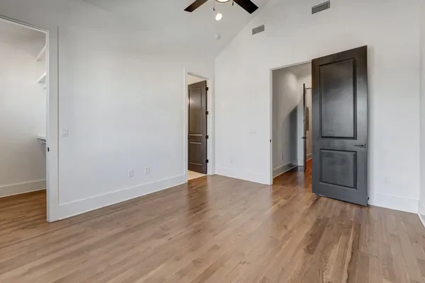 a view of a hallway with wooden floor