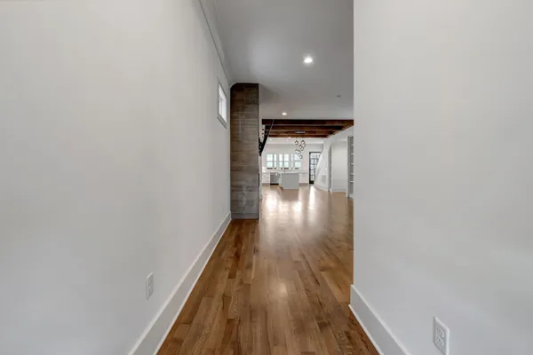 a view of a hallway with wooden floor