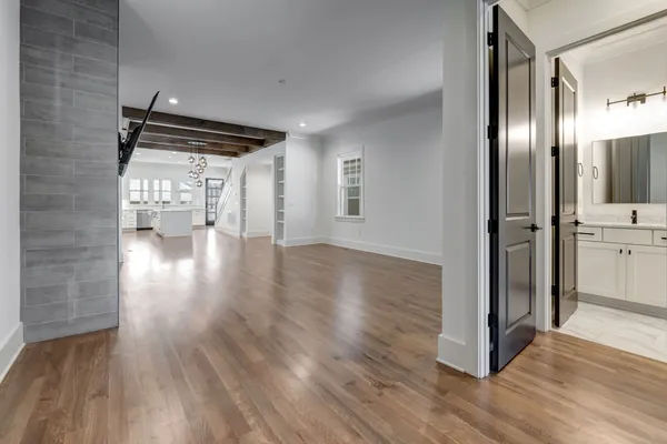 a view of empty room with wooden floor and fireplace