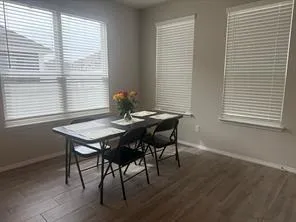 a view of a dining room with furniture and window