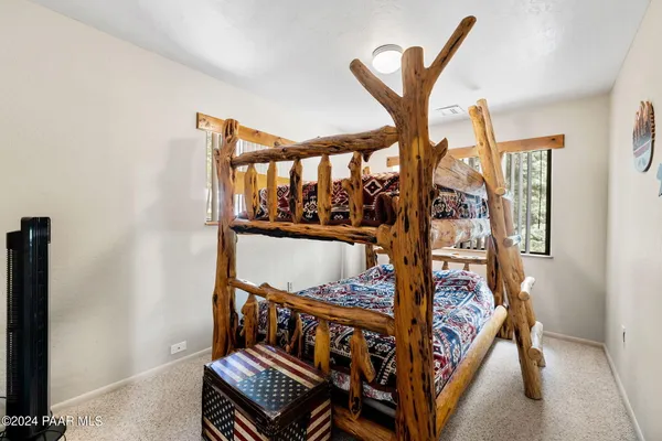 a bedroom with two beds and a window
