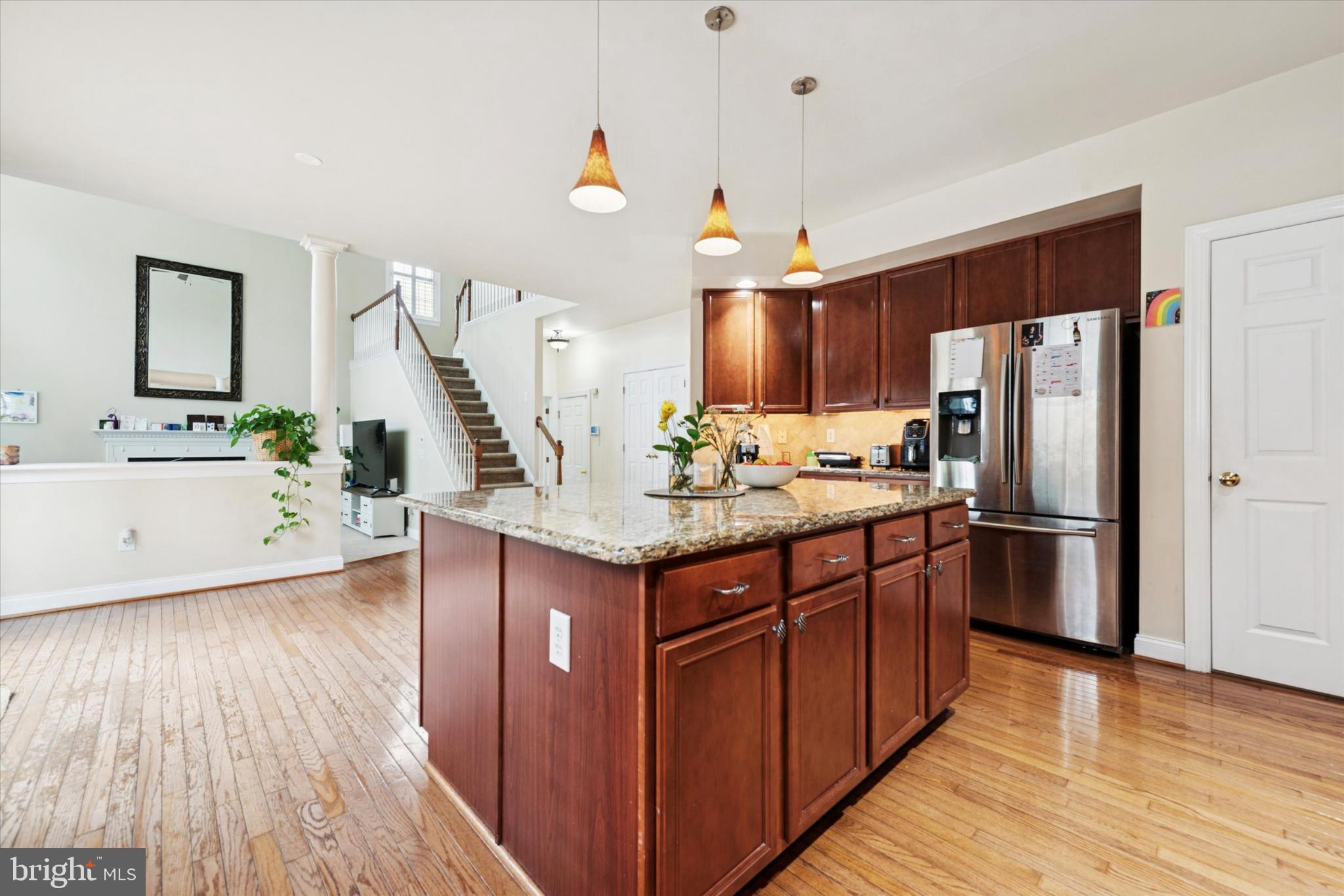 103 Palsgrove Way Chester Springs, PA 19425 - Photo 12 of 35 a kitchen with stainless steel appliances granite countertop a refrigerator a sink dishwasher a stove and white countertops with wooden floor