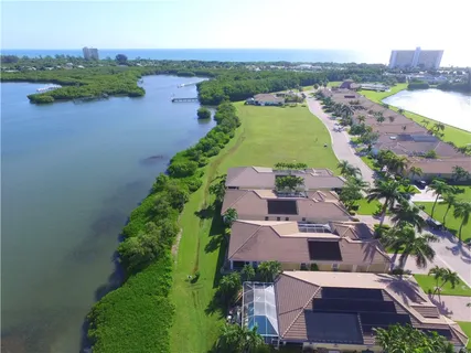 an aerial view of a house with garden space and lake view