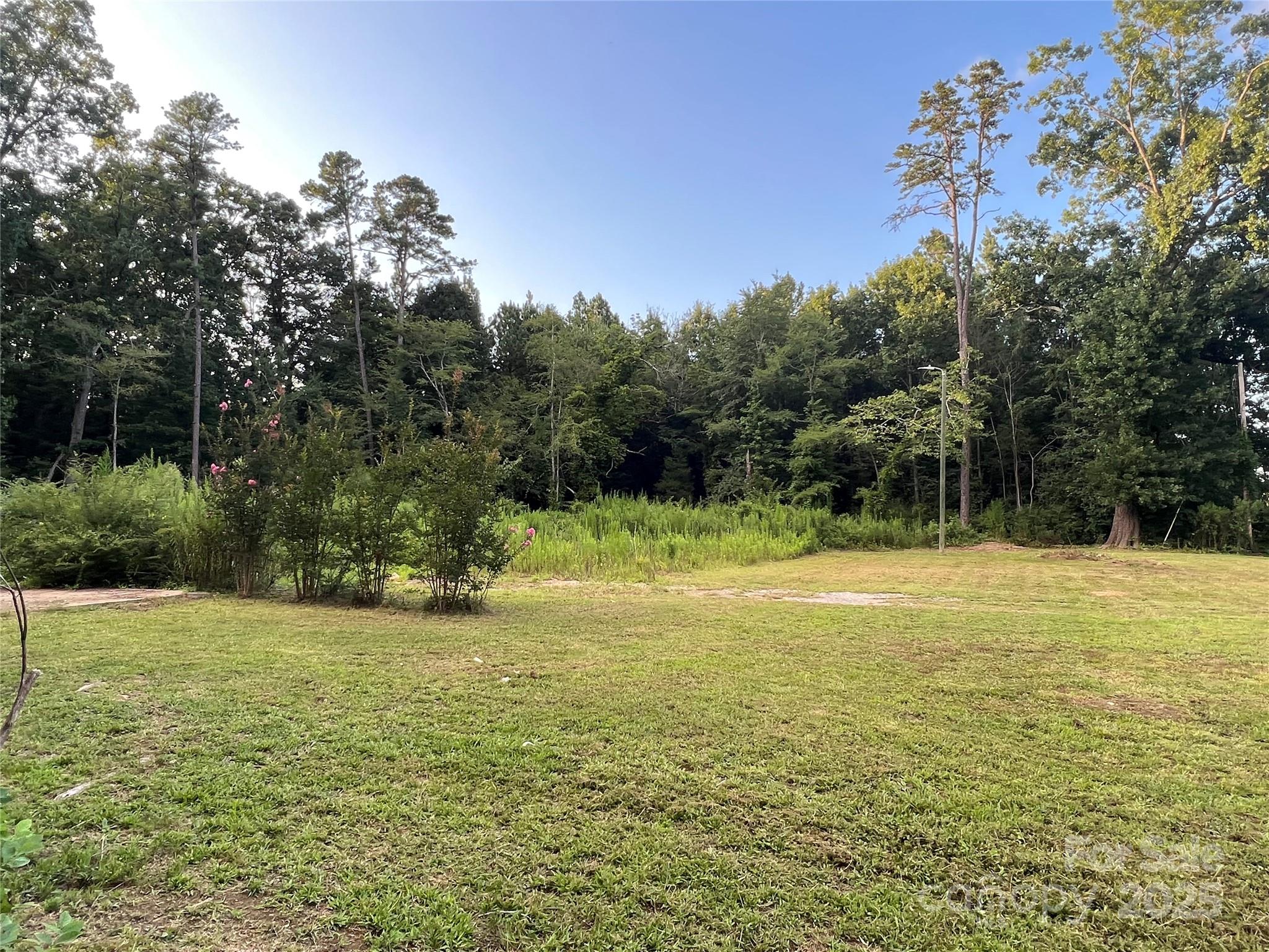 12320 Highway 601 Midland, NC 28107 - Photo 3 of 5 a view of a green yard with a house in the background