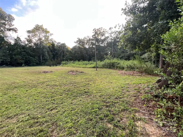 a view of outdoor space with pool and trees around