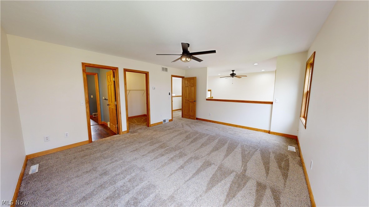 15548 Trask Road Thompson, OH 44086 - Photo 20 of 31 Master bedroom featuring ceiling fan and walk in closet
