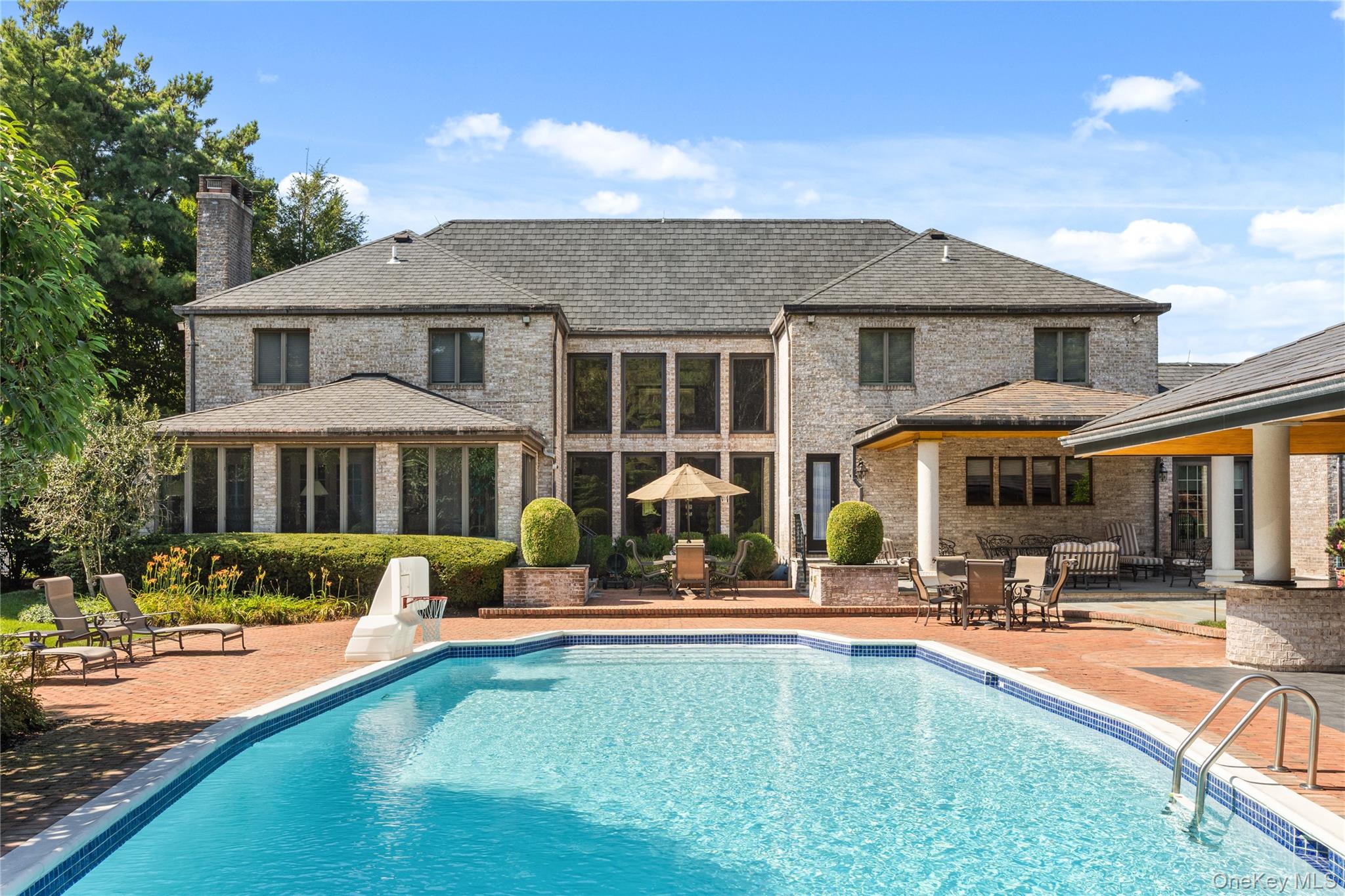 294 Half Hollow Road Dix Hills, NY 11746 - Photo 15 of 44 swimming pool view with a seating space and a garden view