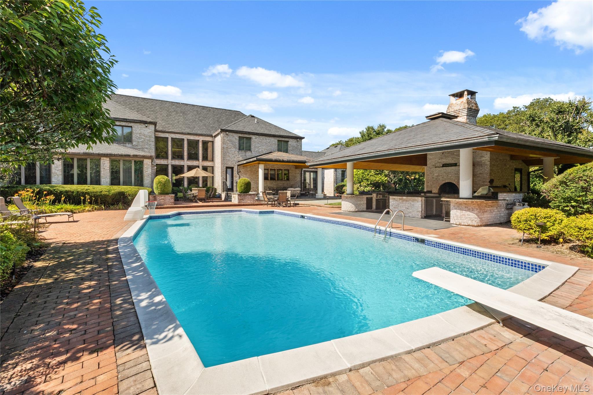 294 Half Hollow Road Dix Hills, NY 11746 - Photo 16 of 44 a view of a house with swimming pool and sitting area