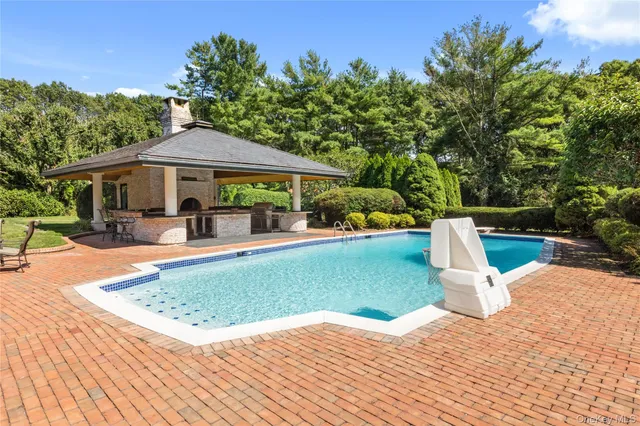 a view of a house with a yard patio and fire pit