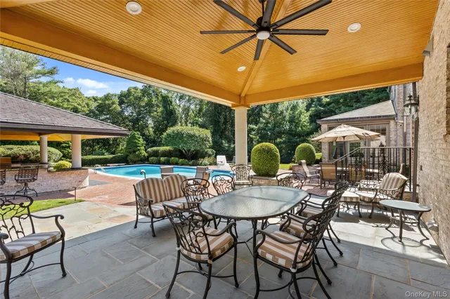 a view of patio with table and chairs under an umbrella