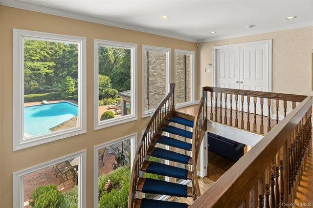 a view of an entryway with wooden floor and stairs