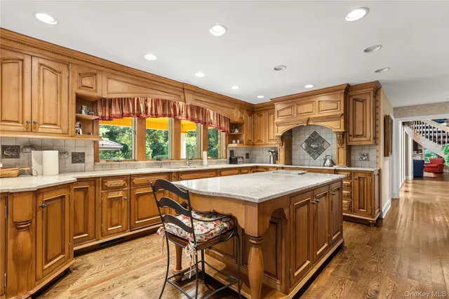a kitchen with stainless steel appliances granite countertop a stove a sink and a refrigerator