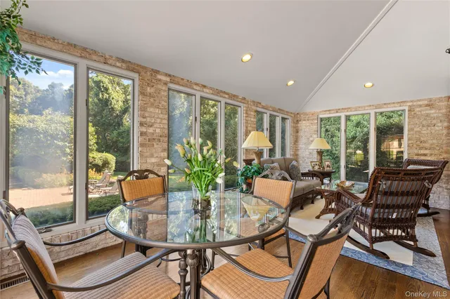 a dining room with furniture a chandelier and wooden floor