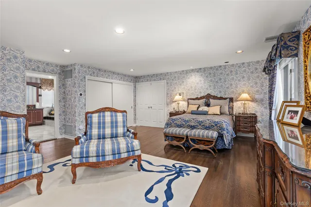 a bedroom with furniture and a wooden floor