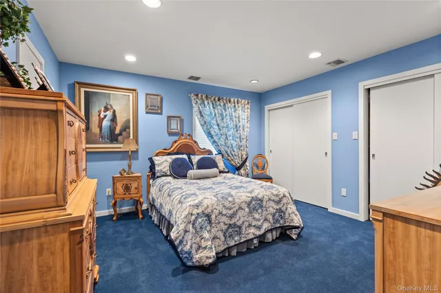 a bedroom with 2 bed and a dresser