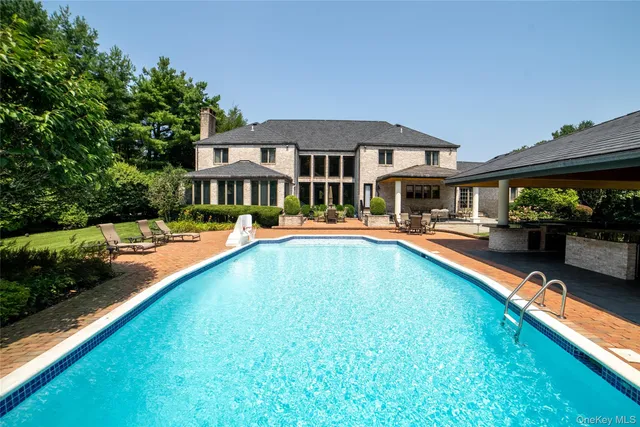 a swimming pool view with a outdoor seating