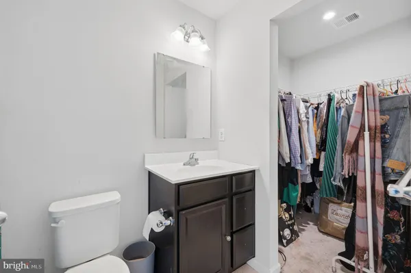 a bathroom with a toilet a sink and a mirror