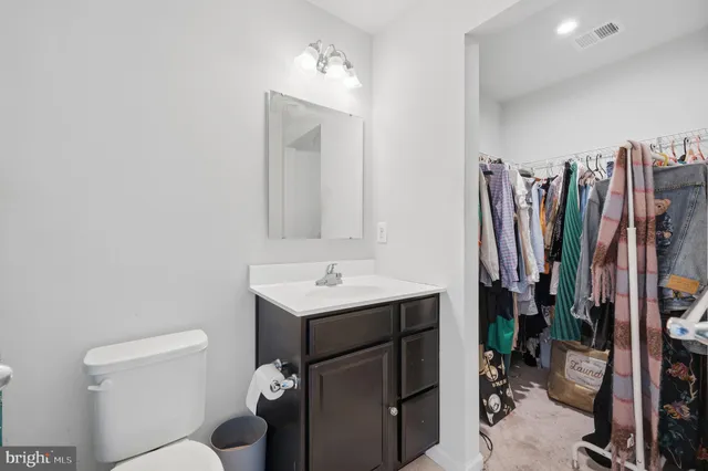a bathroom with a toilet a sink and a mirror