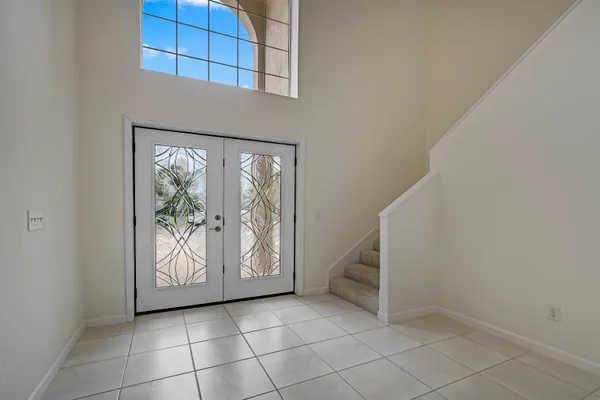 a view of a livingroom with a fireplace a ceiling fan a fireplace and windows