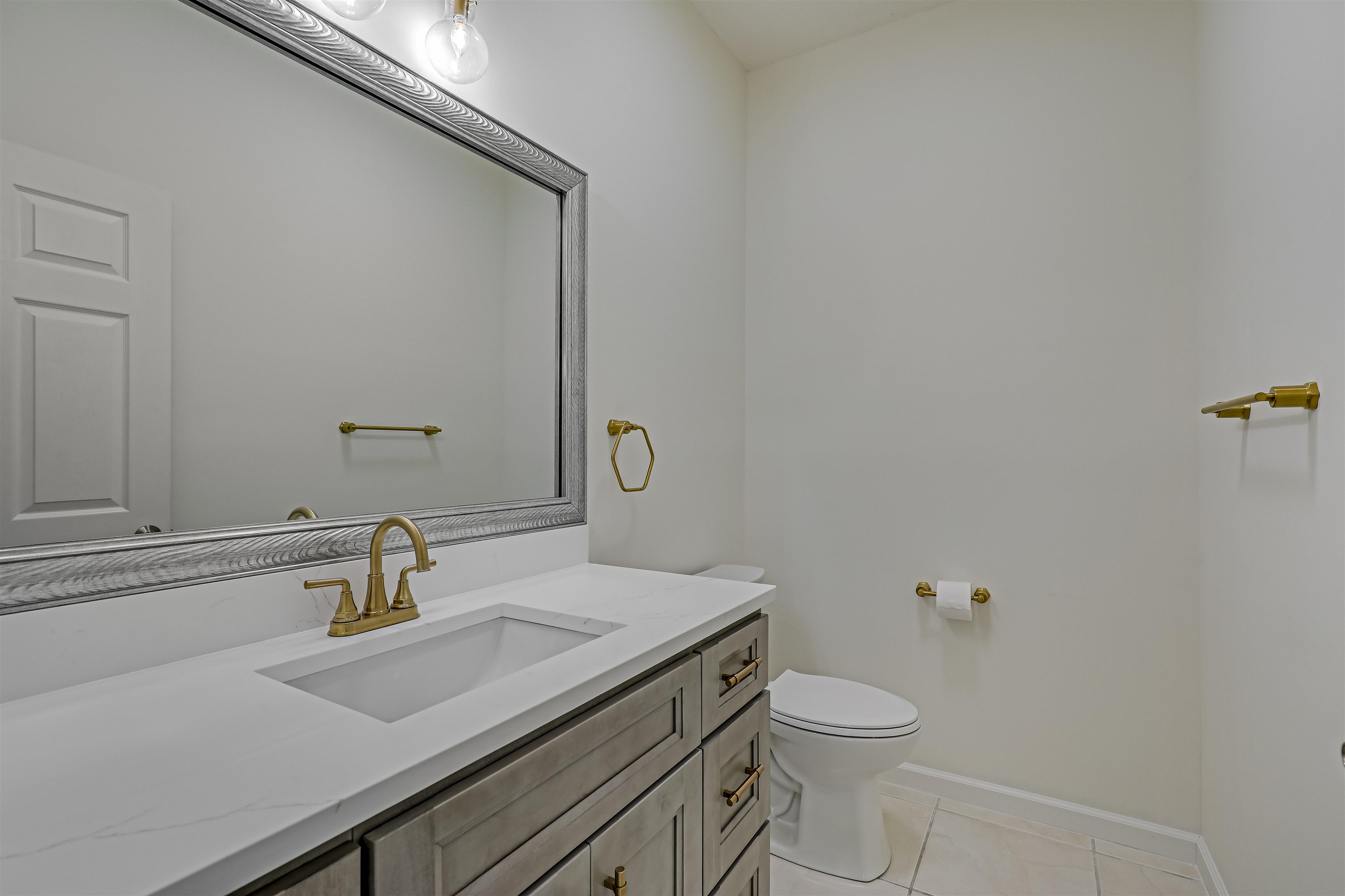 9162 August Circle St. Augustine, FL 32080 - Photo 19 of 81 a bathroom with a sink a toilet and mirror