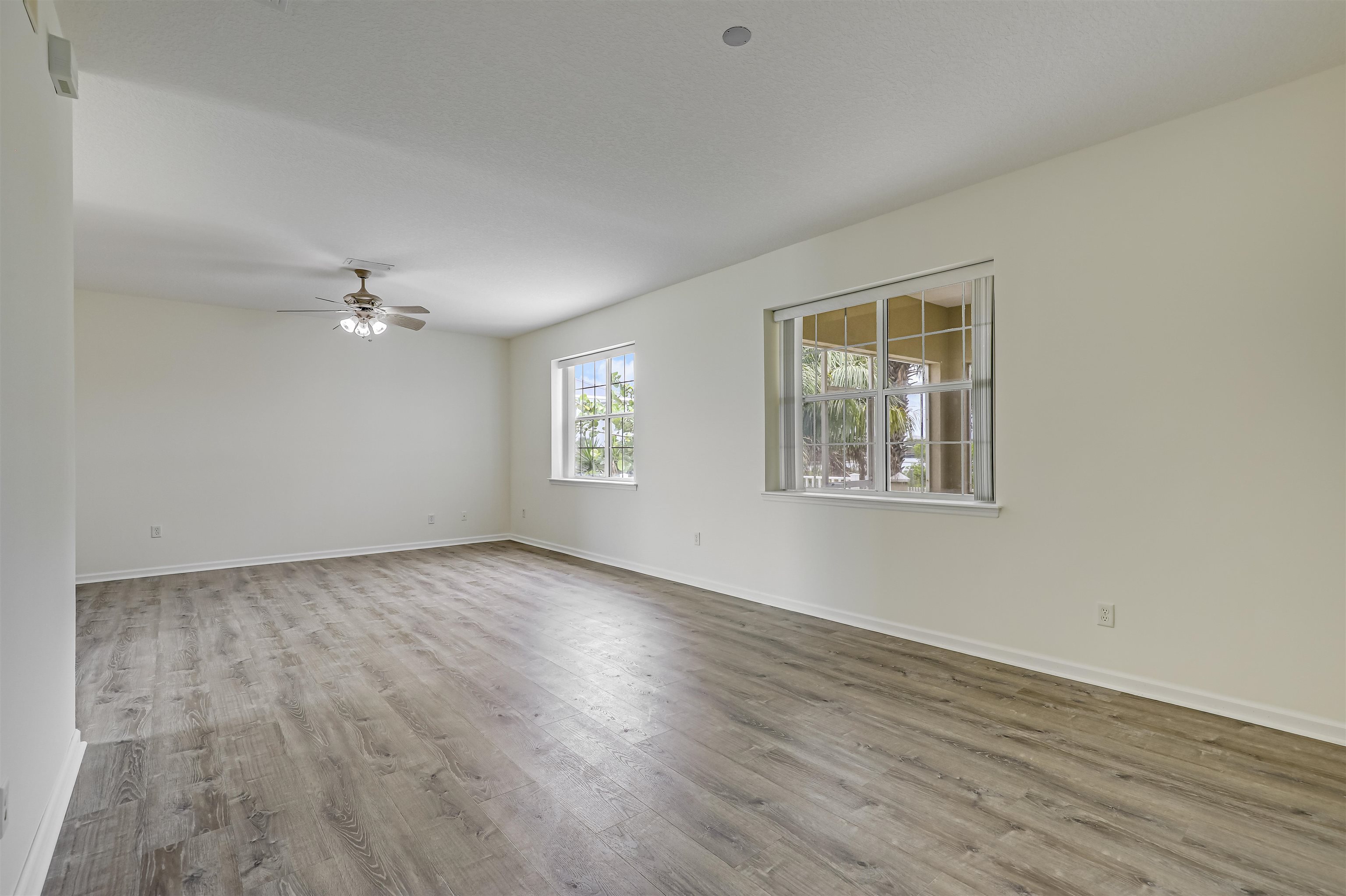 9162 August Circle St. Augustine, FL 32080 - Photo 20 of 81 a view of an empty room with wooden floor and a window