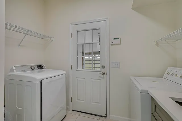 a view of a big room with windows and chandelier fan