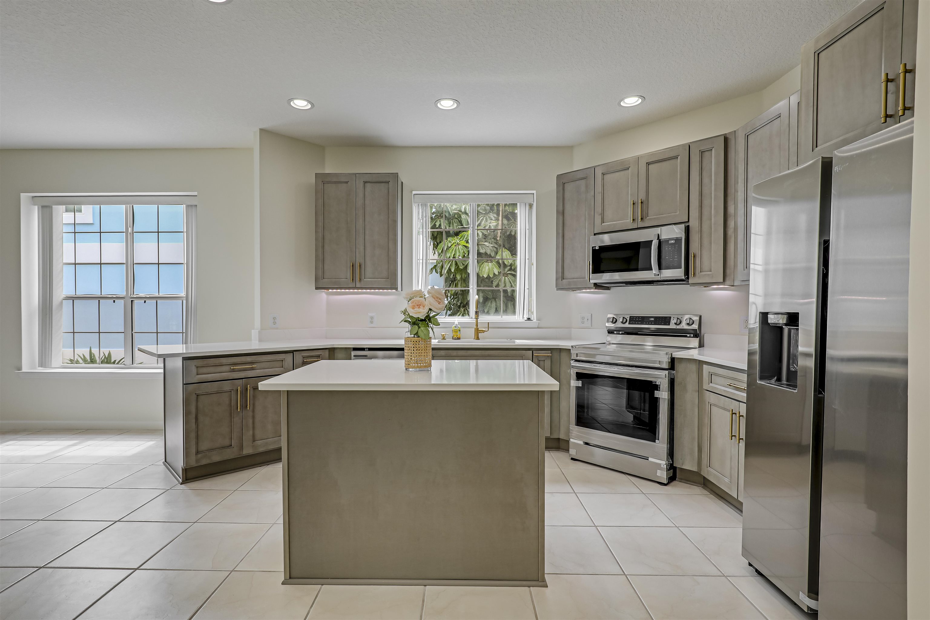 9162 August Circle St. Augustine, FL 32080 - Photo 24 of 81 a kitchen with stainless steel appliances granite countertop a stove top oven a sink dishwasher a refrigerator and a oven with wooden cabinets