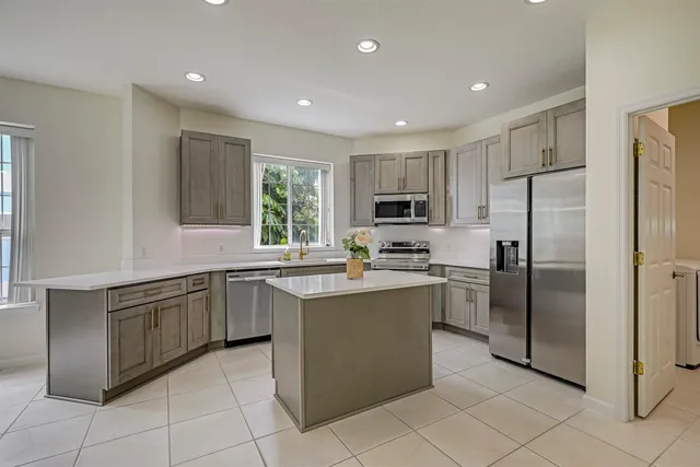 a spacious en suite bathroom with a double vanity sink and a mirror