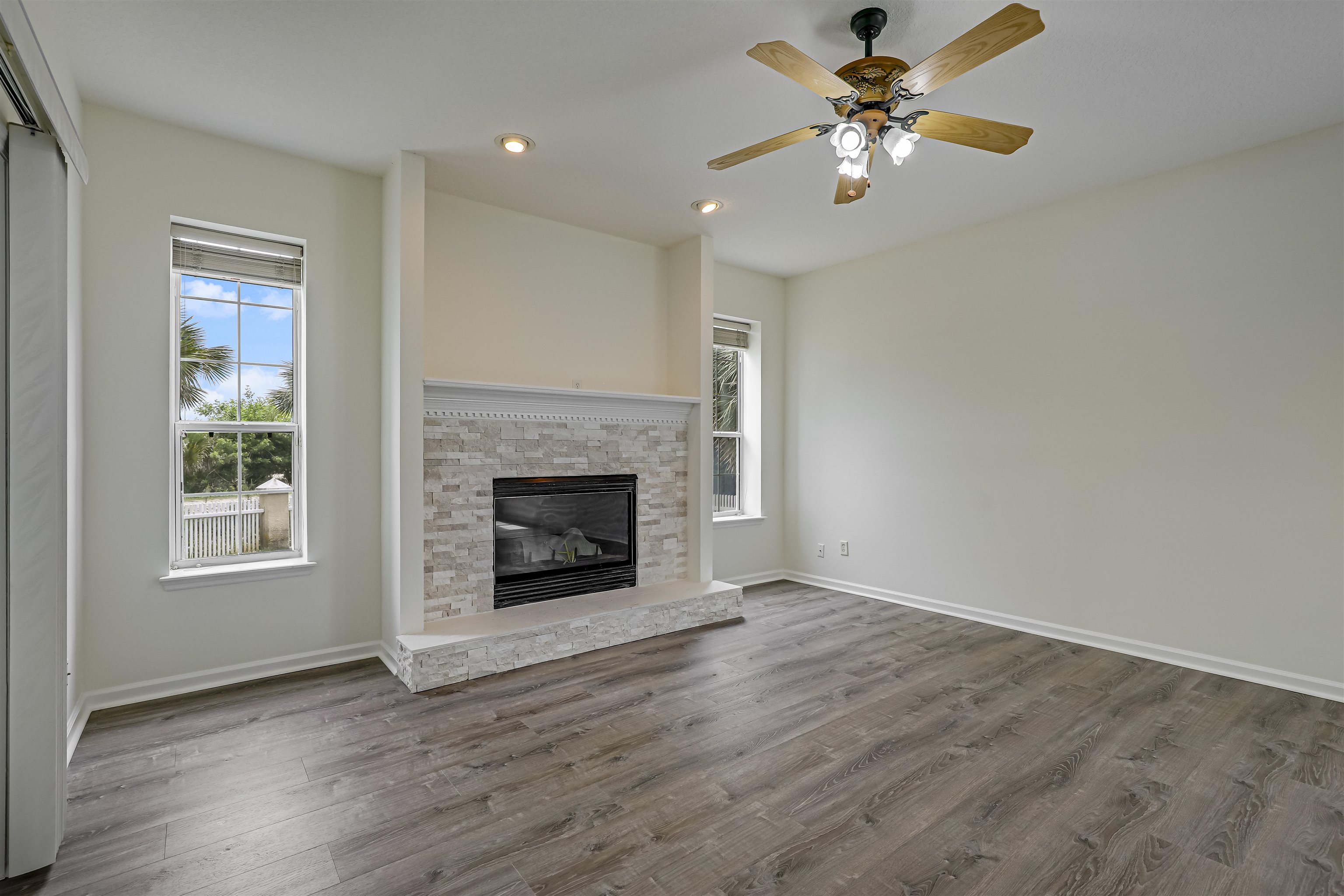 9162 August Circle St. Augustine, FL 32080 - Photo 30 of 81 a view of a livingroom with a fireplace a ceiling fan a fireplace and windows