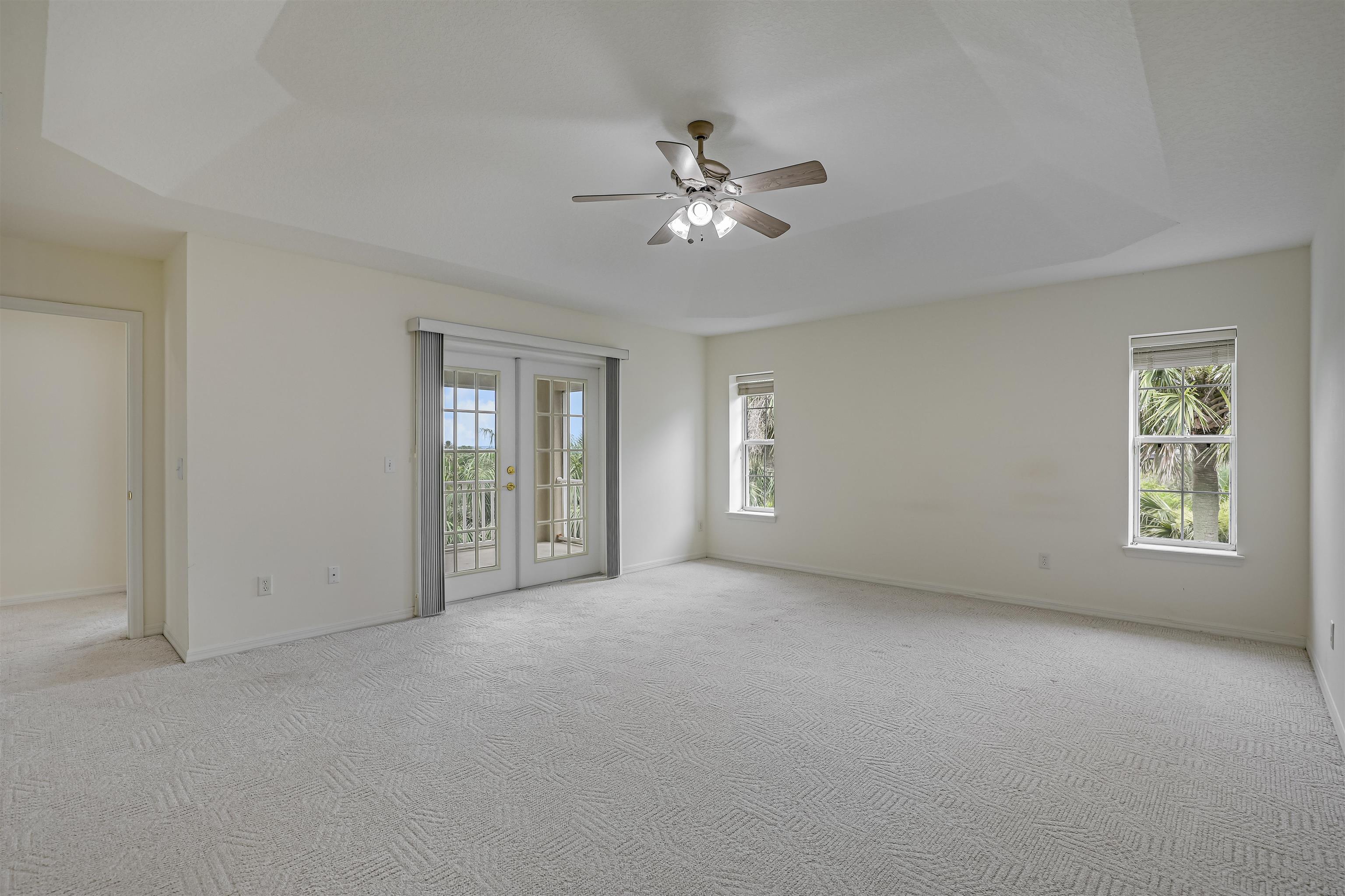 9162 August Circle St. Augustine, FL 32080 - Photo 38 of 81 a view of a big room with windows and chandelier fan