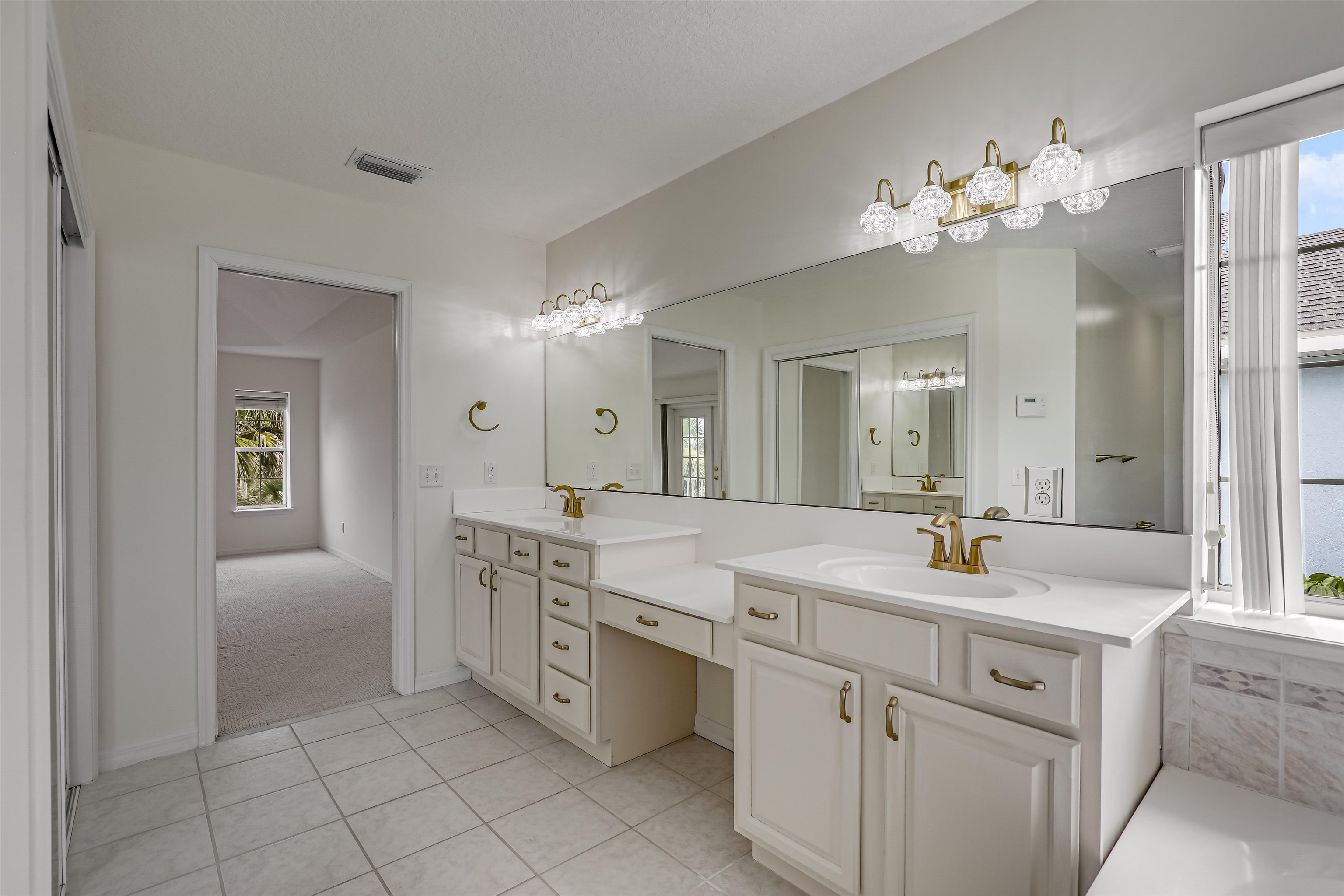 9162 August Circle St. Augustine, FL 32080 - Photo 43 of 81 a spacious en suite bathroom with a double vanity sink and a mirror