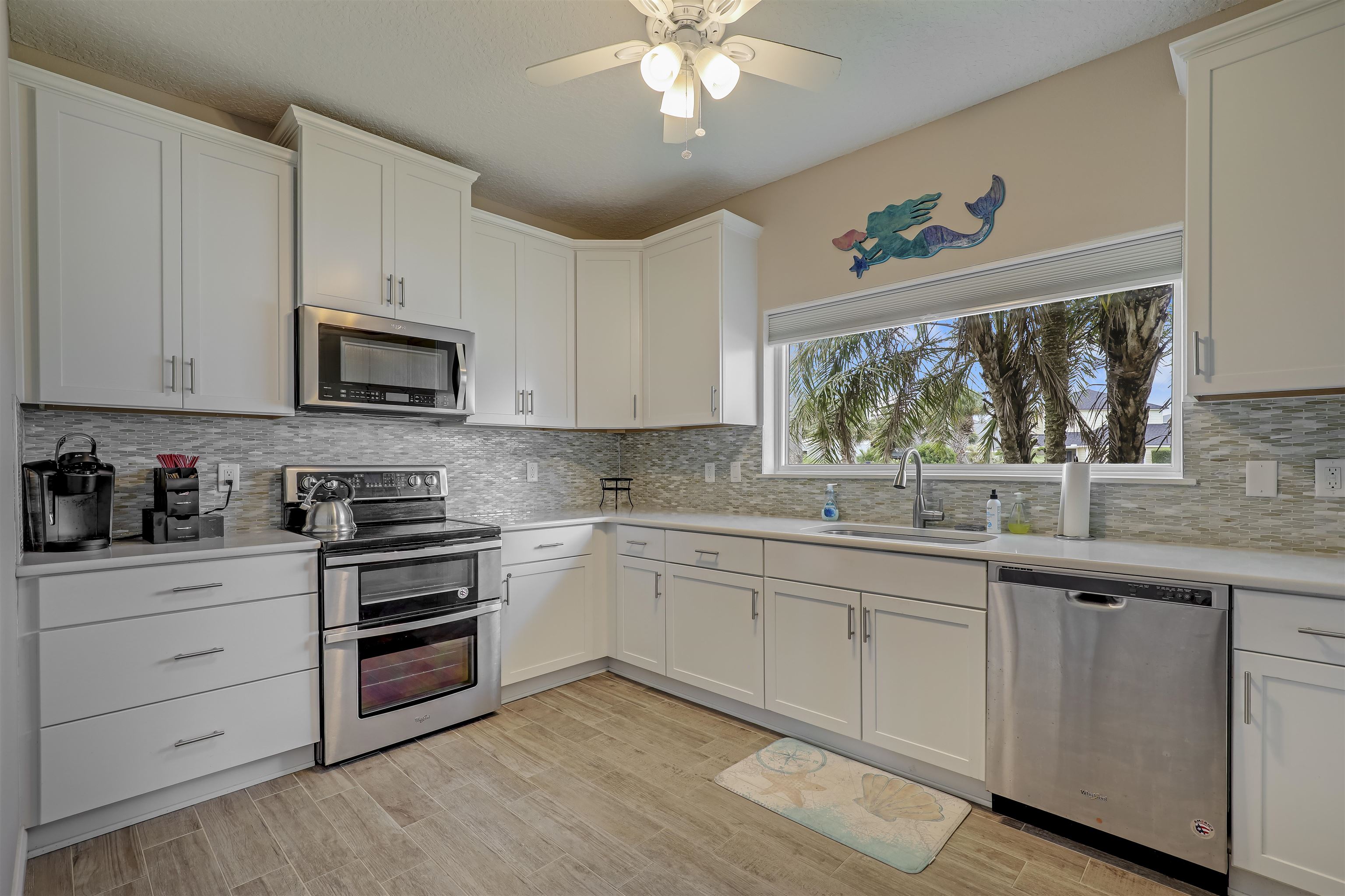 9162 August Circle St. Augustine, FL 32080 - Photo 61 of 81 a kitchen with a sink stove and microwave