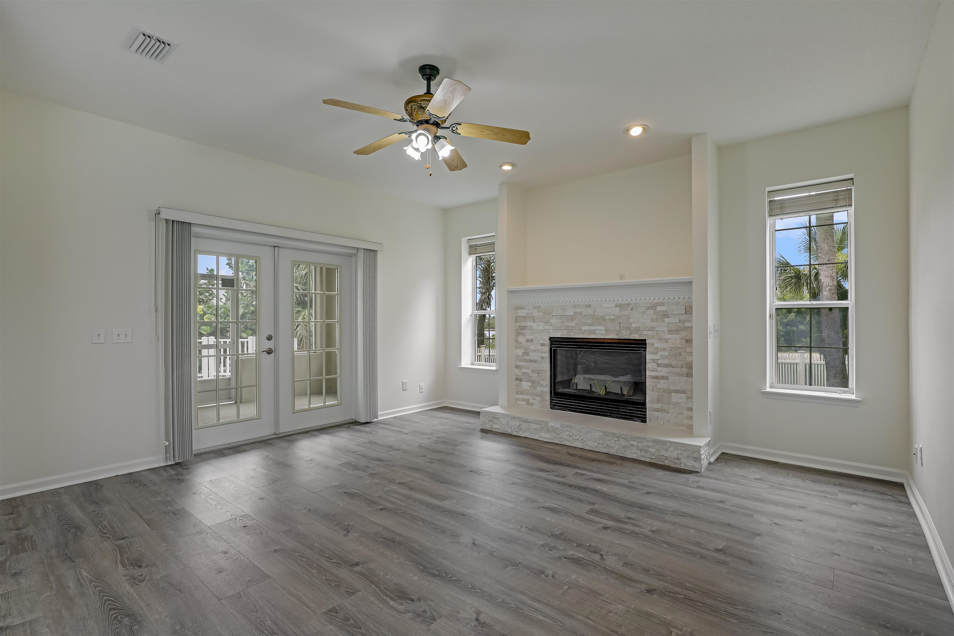 9162 August Circle St. Augustine, FL 32080 - Photo 7 of 81 a view of an empty room with wooden floor fireplace and a window