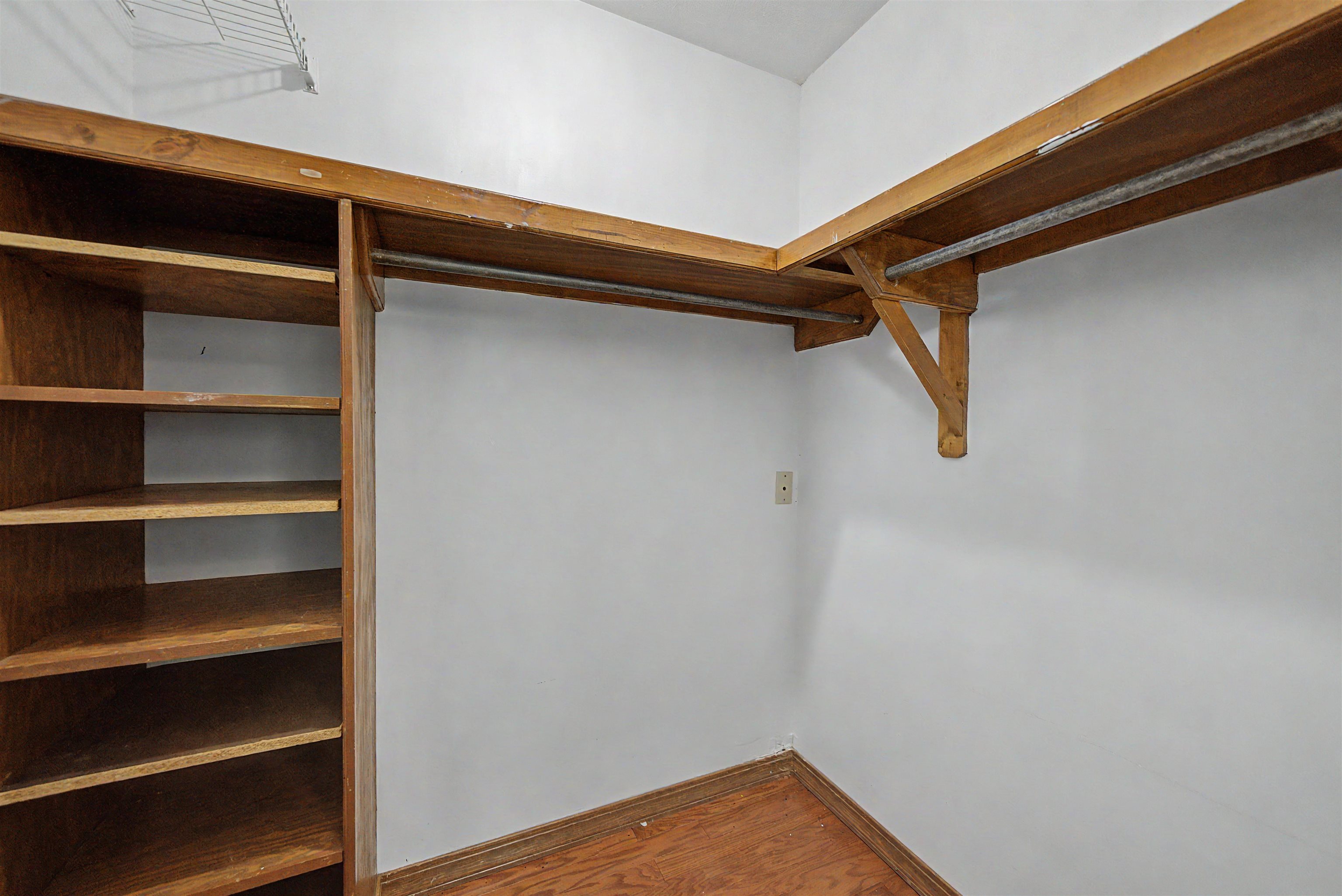 436 Skyline Road Selmer, TN 38375 - Photo 21 of 40 Built-in closet system featuring wood-finish shelving, hanging rods, and wood-finish flooring