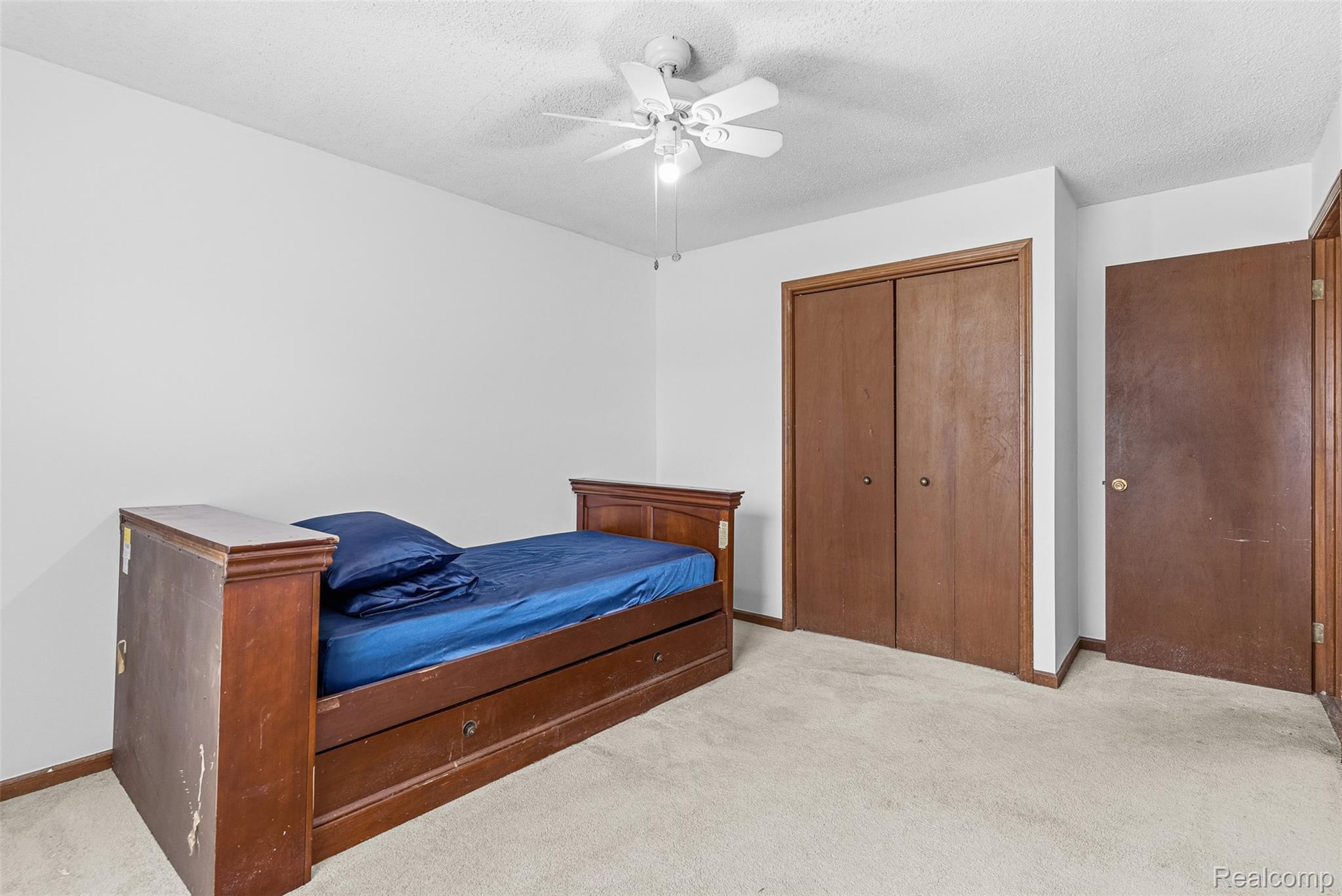 3432 South State Road Davison, MI 48423 - Photo 23 of 58 Carpeted bedroom with a closet, a ceiling fan, and a textured ceiling