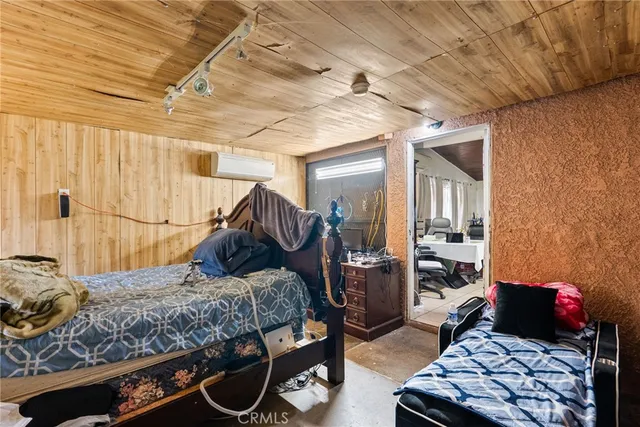 a bedroom with bed and wooden floor