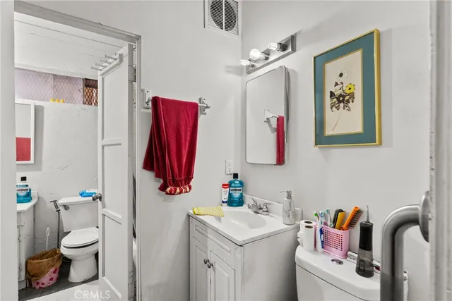 a bathroom with a sink toilet and a bath tub