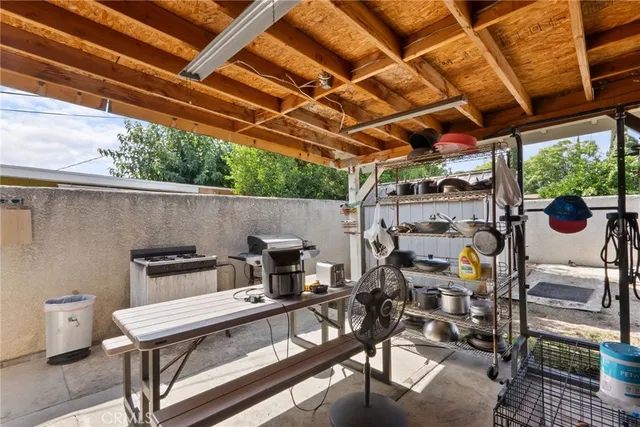 a view of a patio with table and chairs