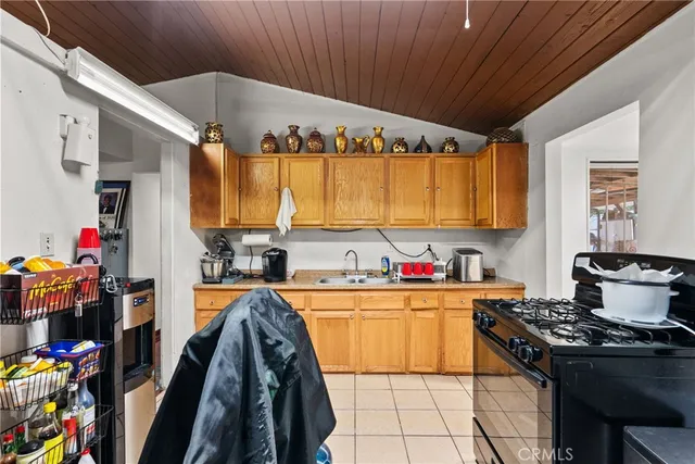 a kitchen that has a lot of cabinets in it and wooden floors