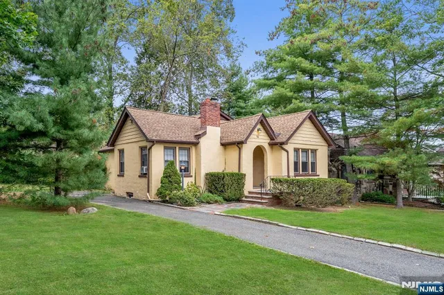 a view of a pathway of a house with fountain in front of it