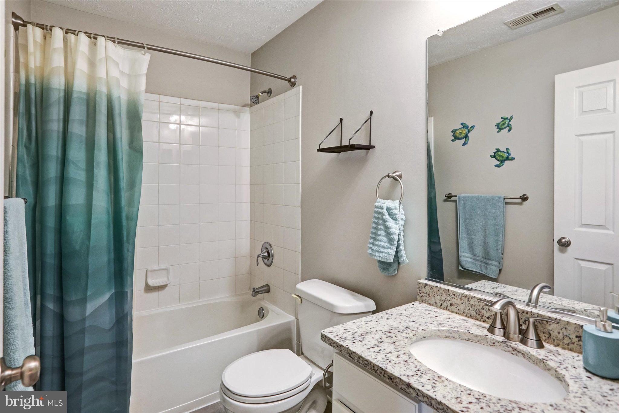 9663 Davison Road Middle River, MD 21220 - Photo 20 of 45 a bathroom with a granite countertop bathtub shower sink vanity and toilet
