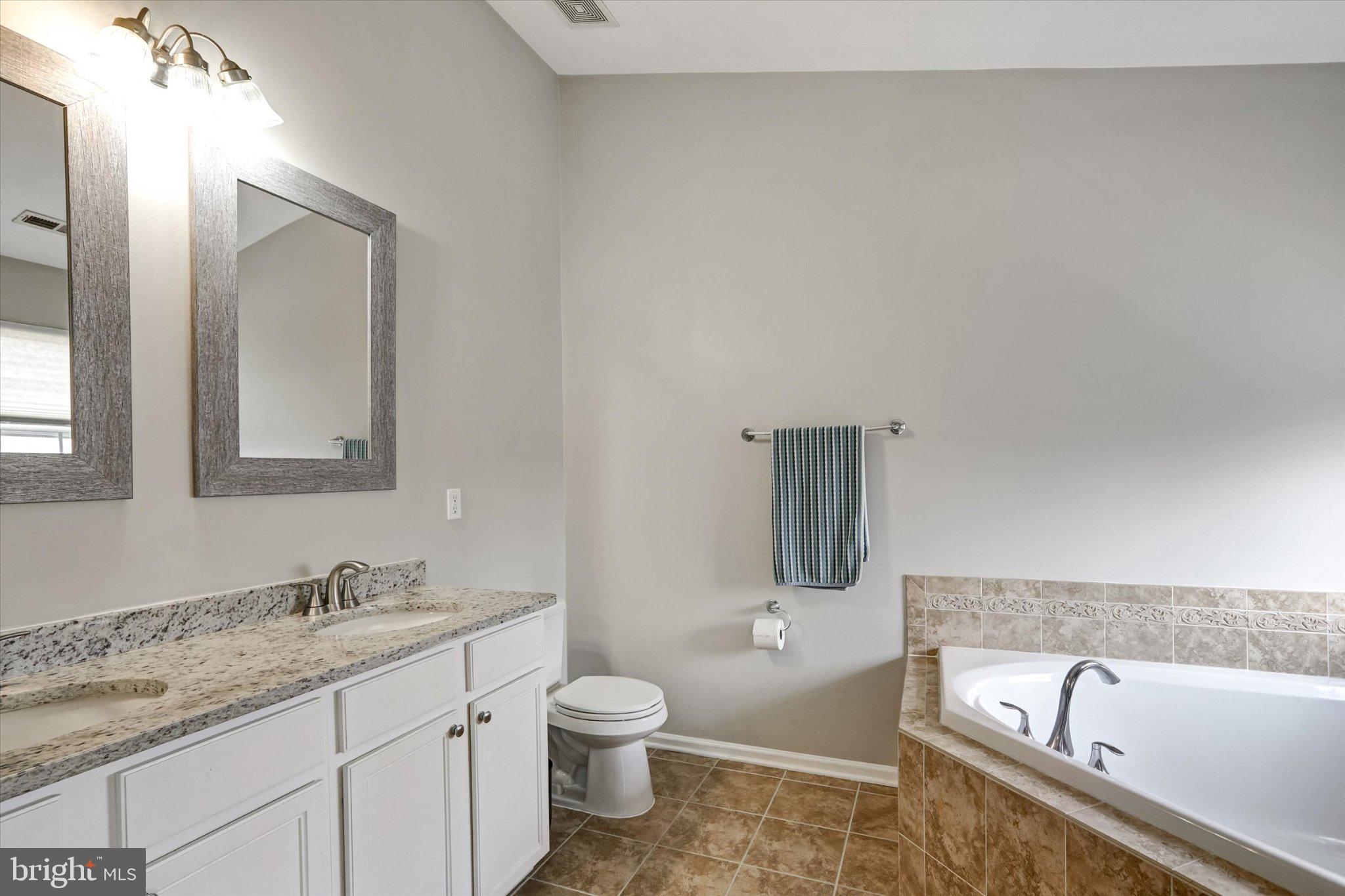 9663 Davison Road Middle River, MD 21220 - Photo 25 of 45 a bathroom with a granite countertop sink bathtub and mirror