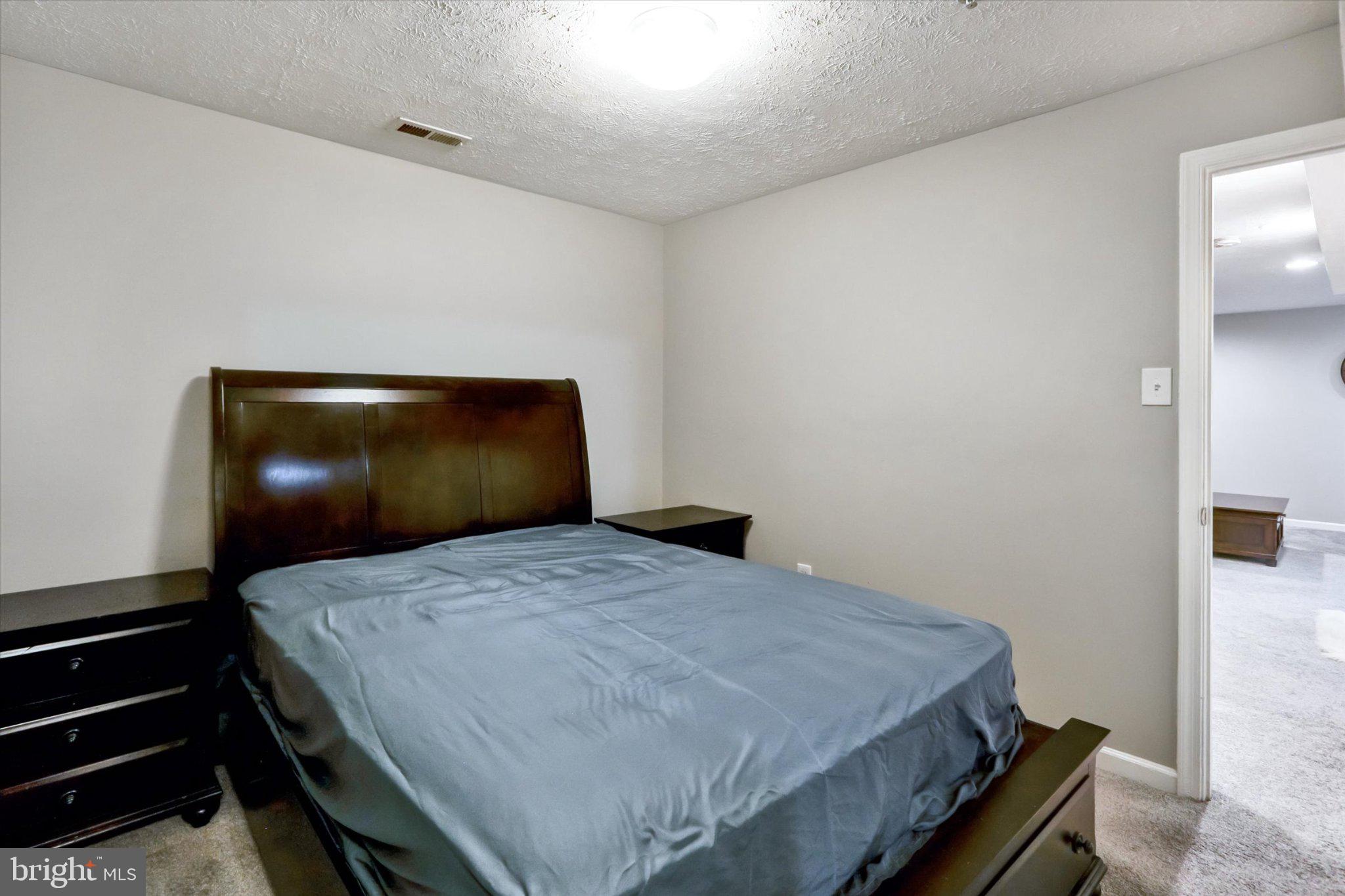 9663 Davison Road Middle River, MD 21220 - Photo 36 of 45 a bedroom with a bed and lamp