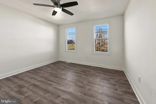 wooden floor in an empty room with a window
