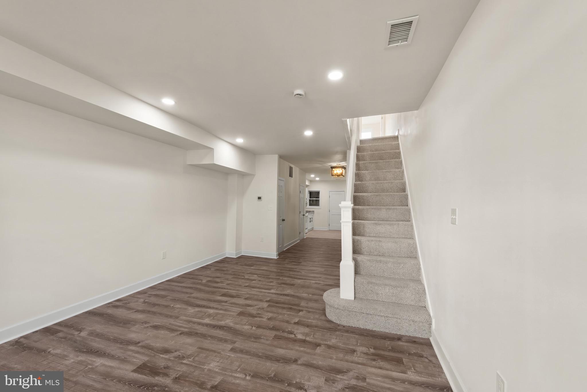 2419 Baker Street Baltimore, MD 21216 - Photo 3 of 40 a view of an empty room with stairs and ventilation